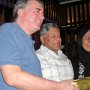 Mick receiving a souvenir from Mo during dinner at Barney's